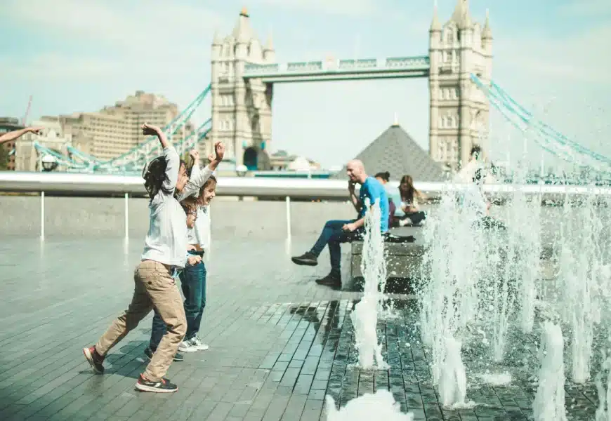 Enfants s'amusants devant des jets d'eau à Londres lors d'un voyage en famille
